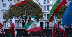 Protester climbs Embassy in London as thousands take to the streets in Iran